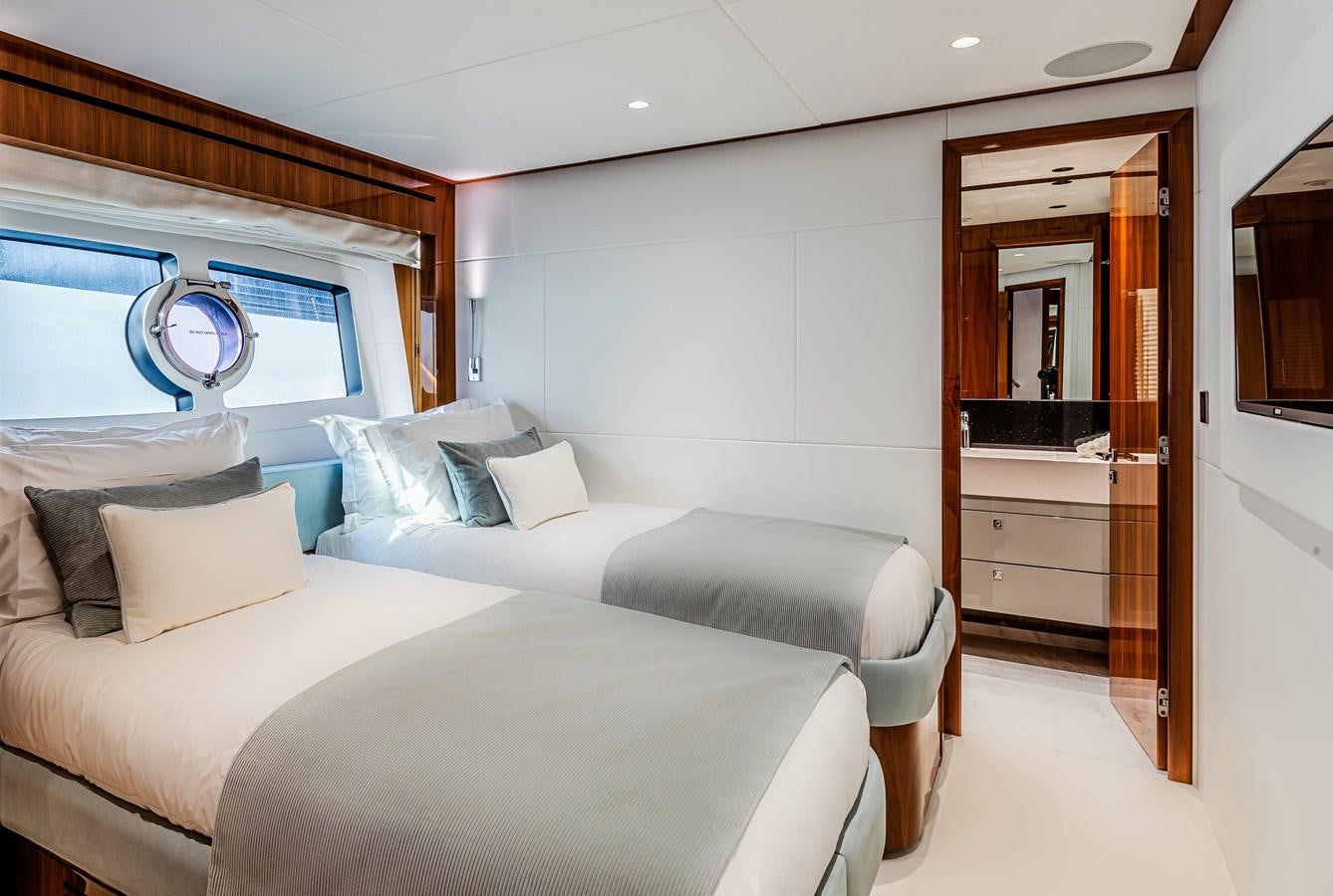a room with two beds aboard KUDOS Yacht for Sale