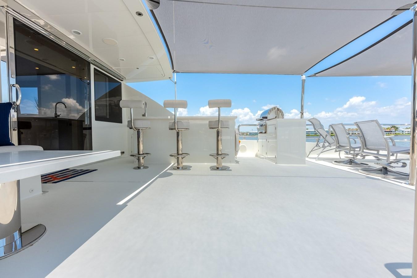 inside of a building with a large white table and chairs and a large window with a view of aboard WIGGLE ROOM Yacht for Sale