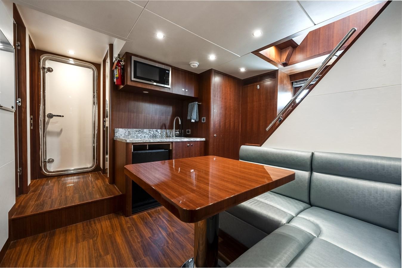 a living room with a wood table aboard WIGGLE ROOM Yacht for Sale