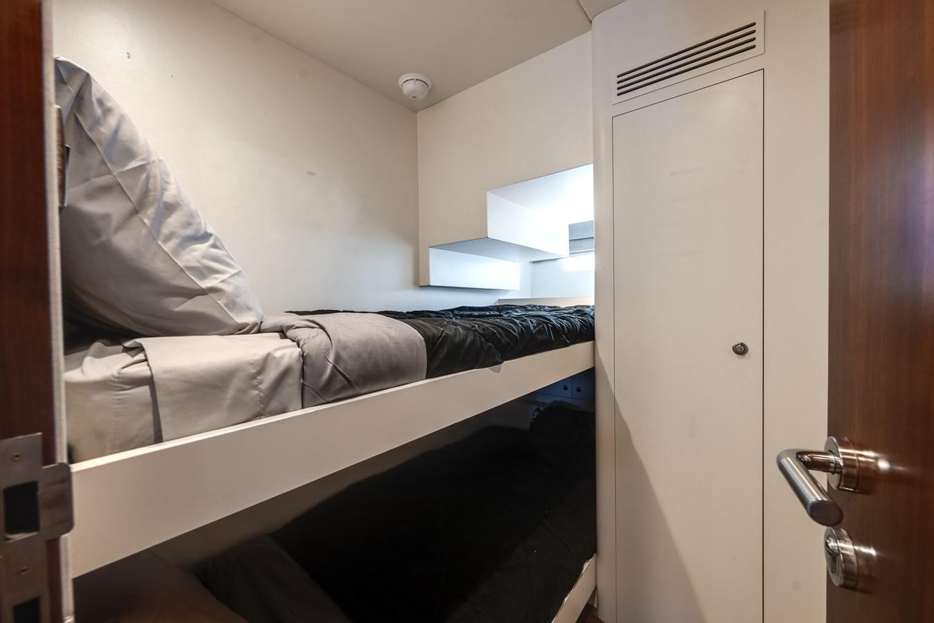 a bed with a white sheet aboard WIGGLE ROOM Yacht for Sale