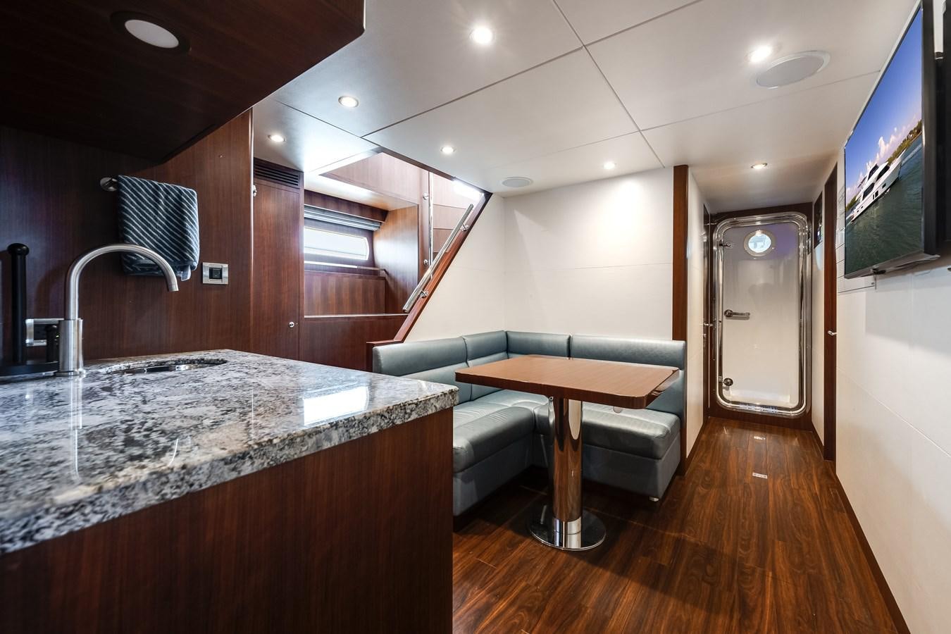 a kitchen with a bar and a table aboard WIGGLE ROOM Yacht for Sale
