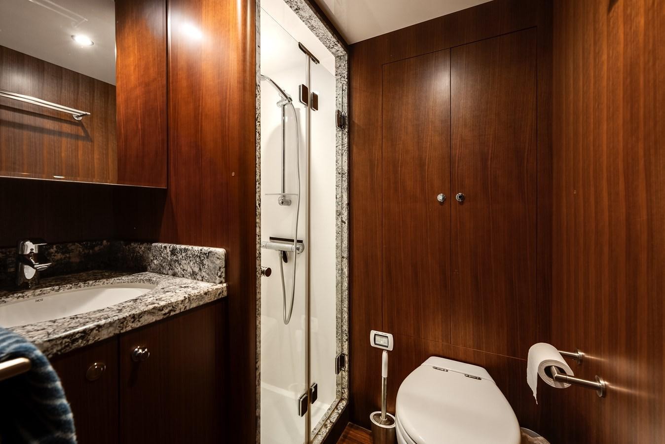 a bathroom with a toilet and a sink aboard WIGGLE ROOM Yacht for Sale