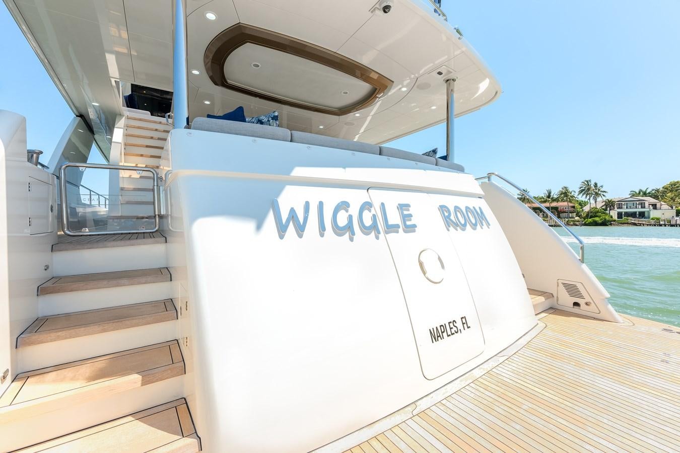 a white boat on a dock aboard WIGGLE ROOM Yacht for Sale