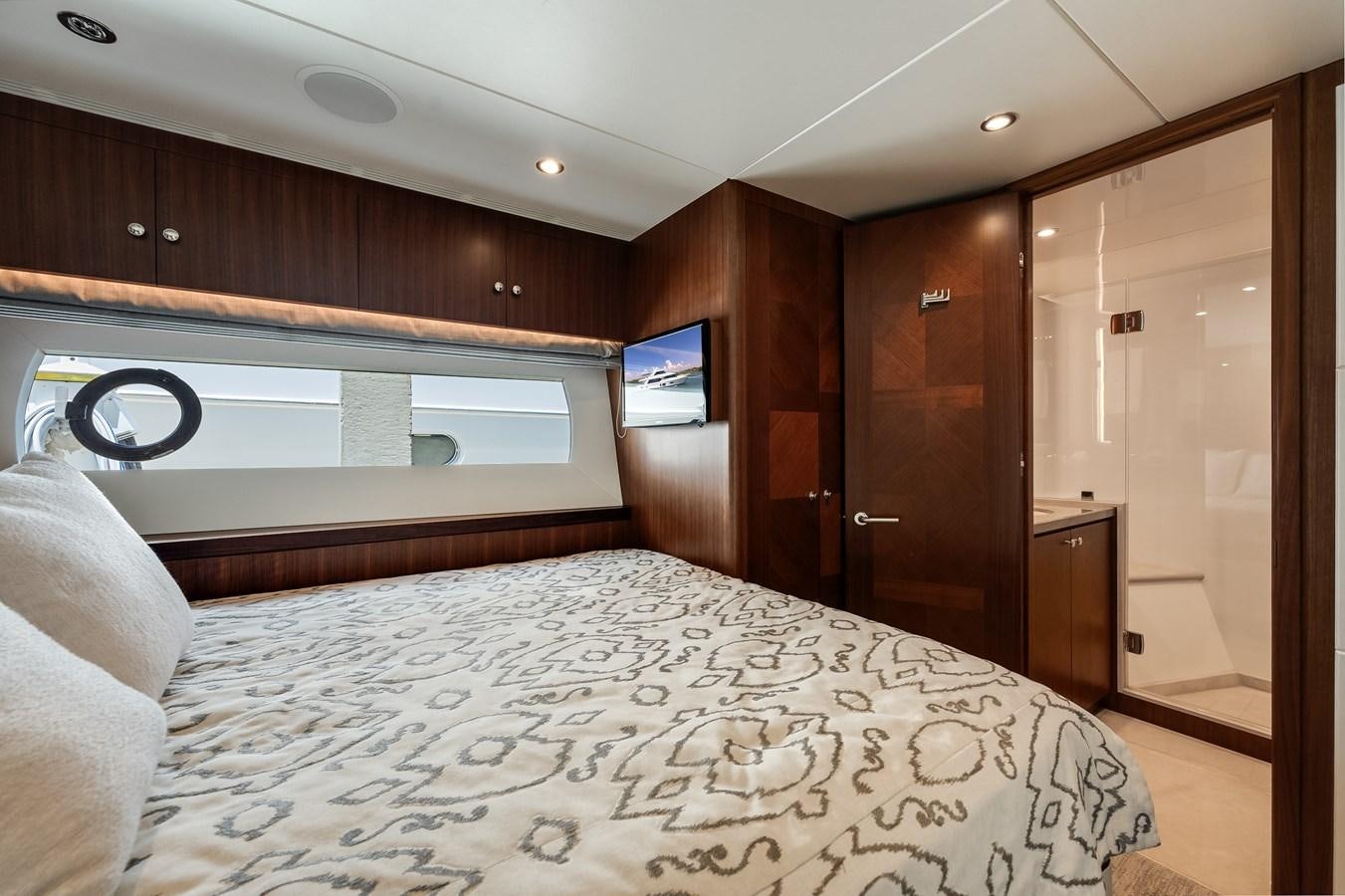 a bedroom with a bed and a television aboard WIGGLE ROOM Yacht for Sale