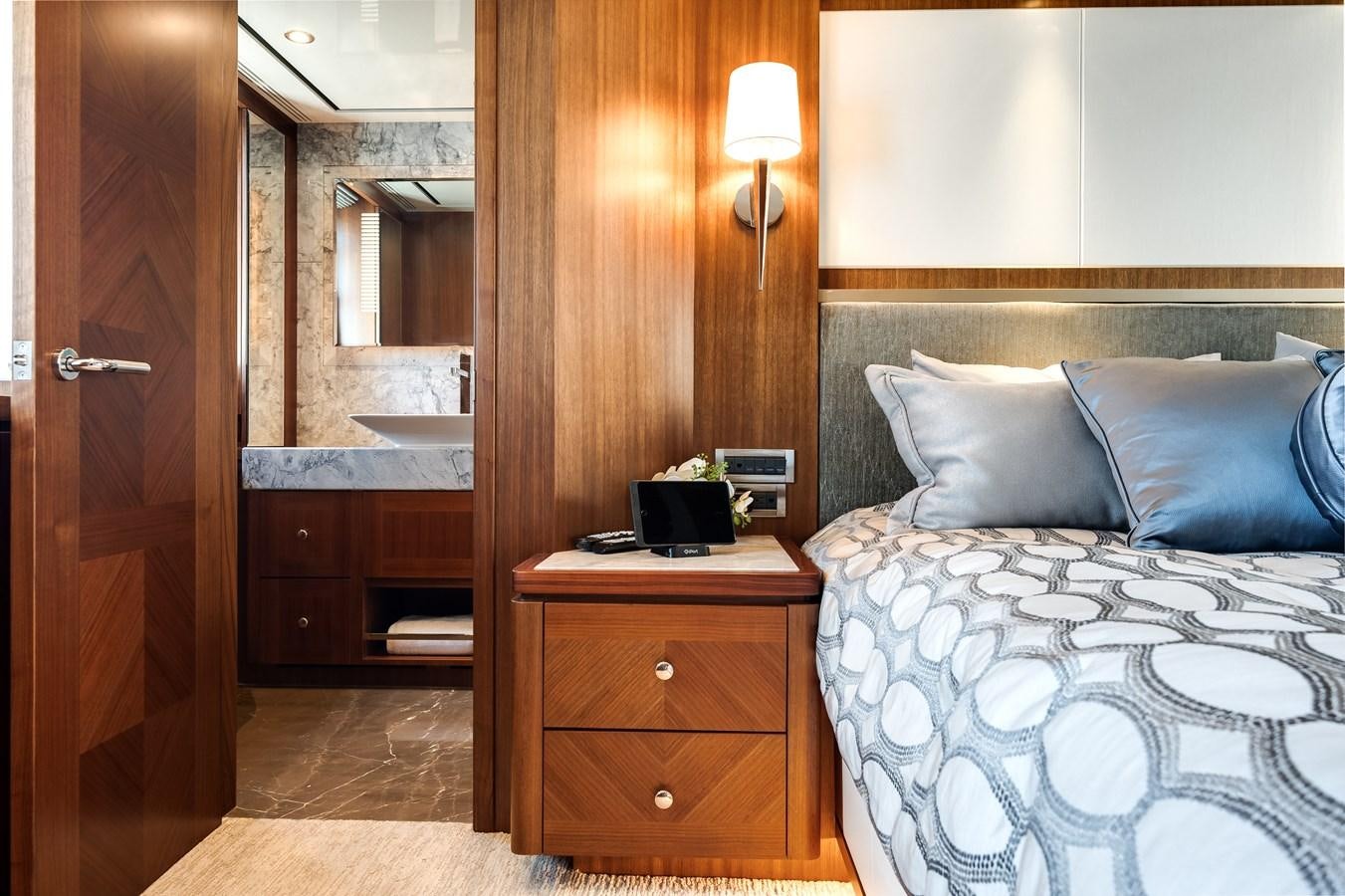 a bedroom with a bed and a mirror aboard WIGGLE ROOM Yacht for Sale