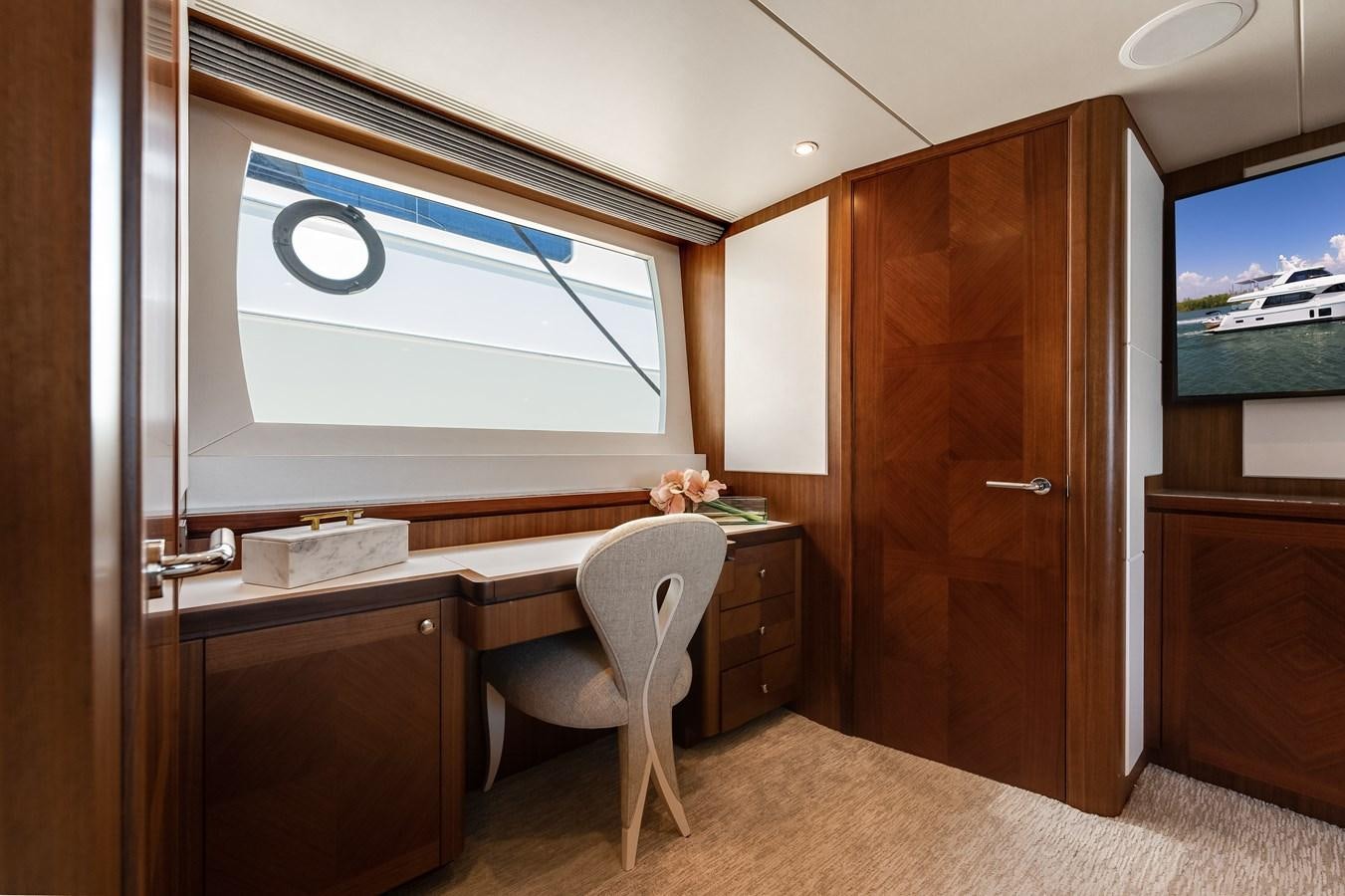 a room with a desk and a tv aboard WIGGLE ROOM Yacht for Sale
