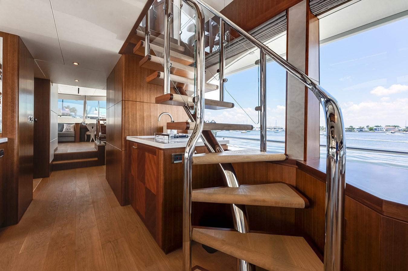 a room with a wood floor and a large window aboard WIGGLE ROOM Yacht for Sale