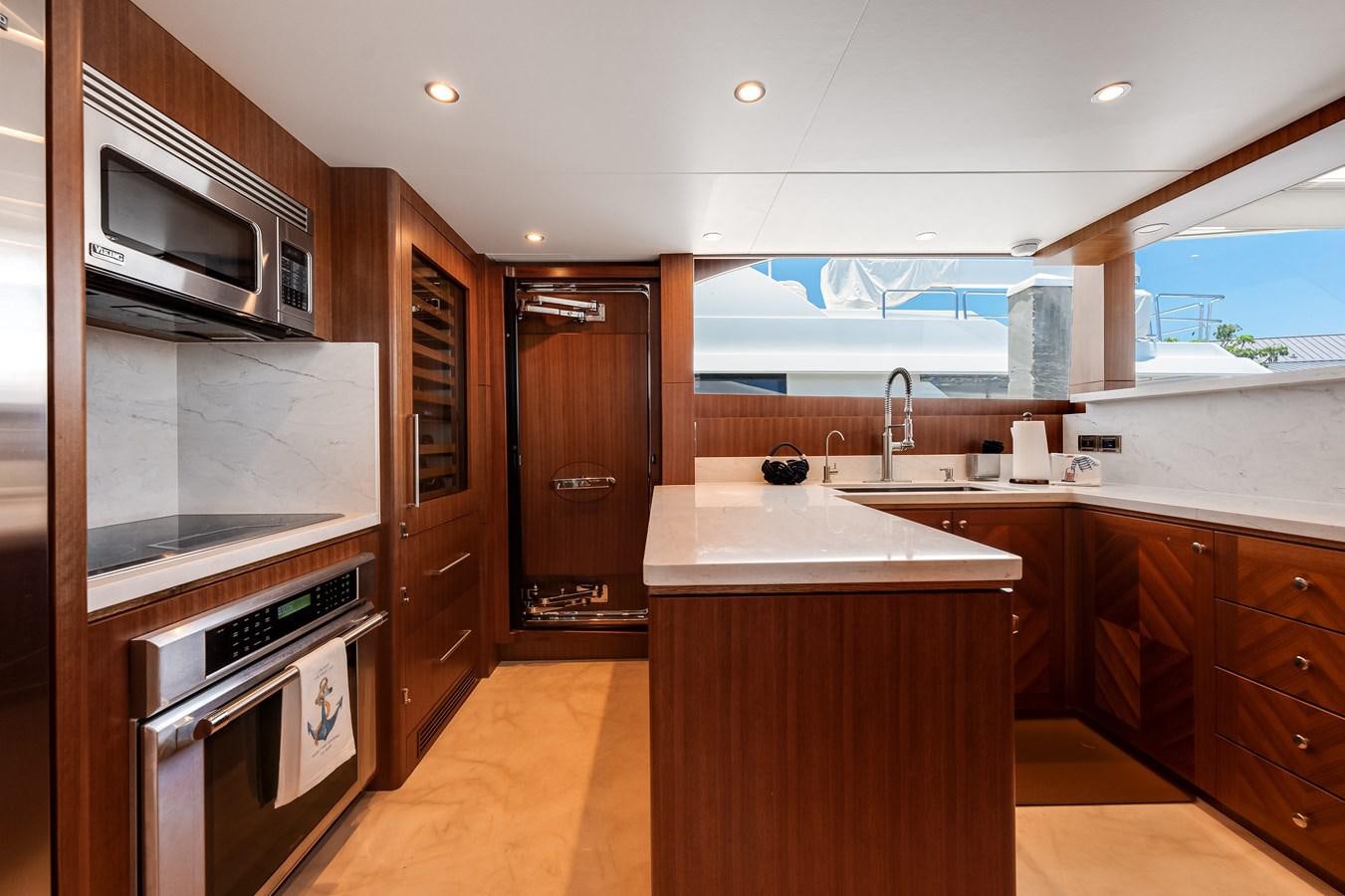 a kitchen with wooden cabinets aboard WIGGLE ROOM Yacht for Sale