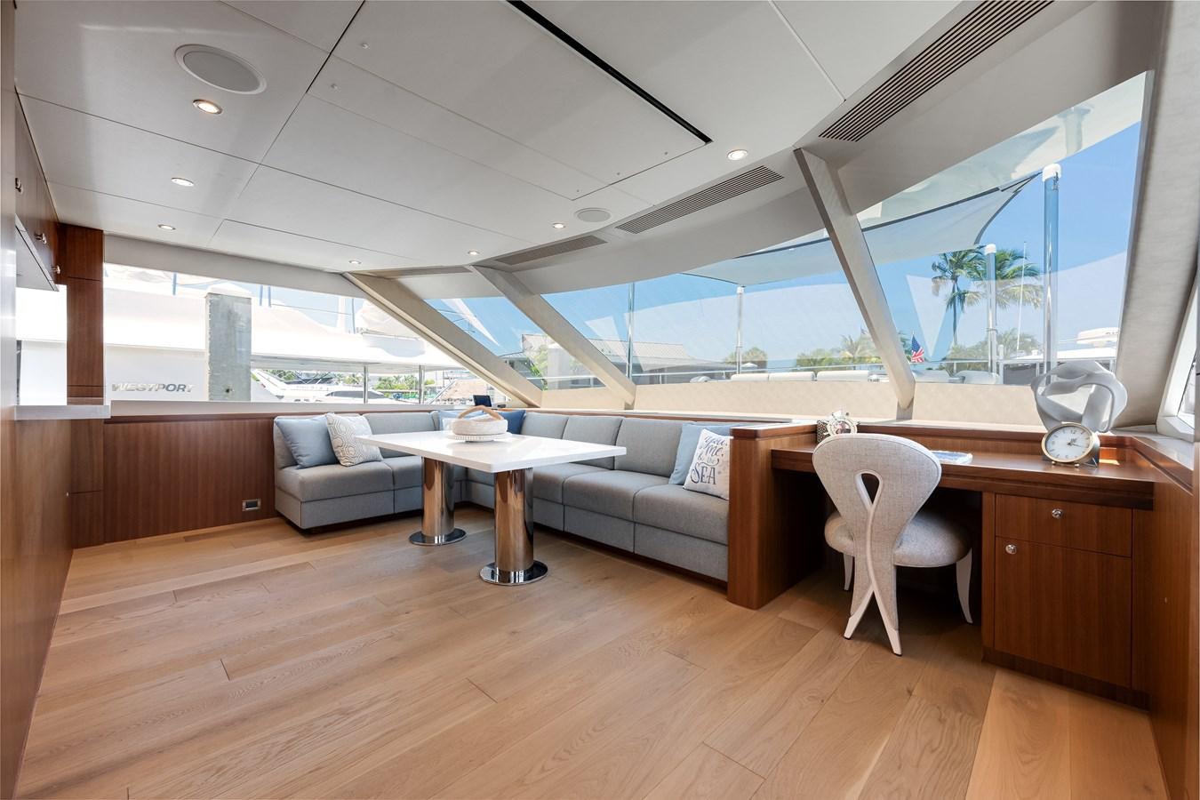 a room with a couch and a table and a window aboard WIGGLE ROOM Yacht for Sale