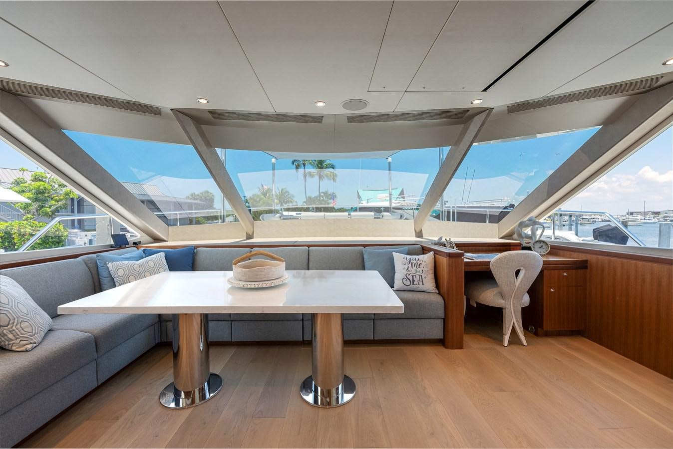 a room with a couch and a table and chairs aboard WIGGLE ROOM Yacht for Sale