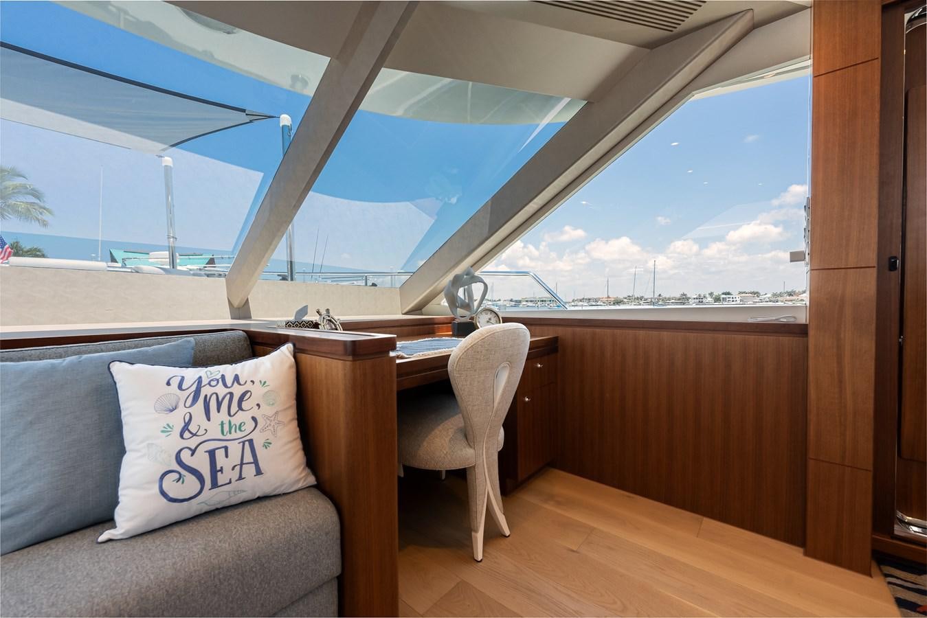a room with a couch and a view of a city aboard WIGGLE ROOM Yacht for Sale
