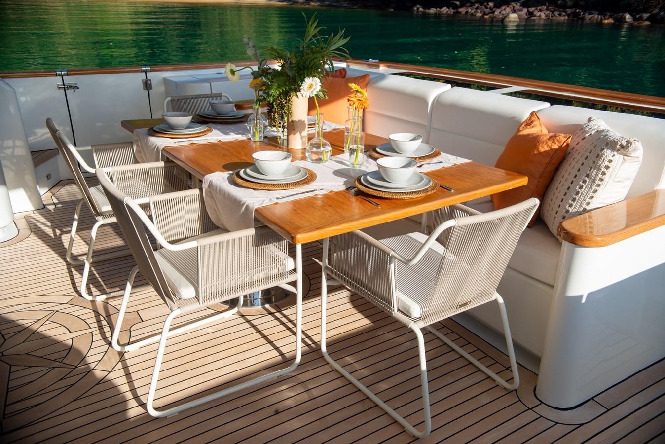 a table with chairs and a couch on it aboard TATI Yacht for Sale