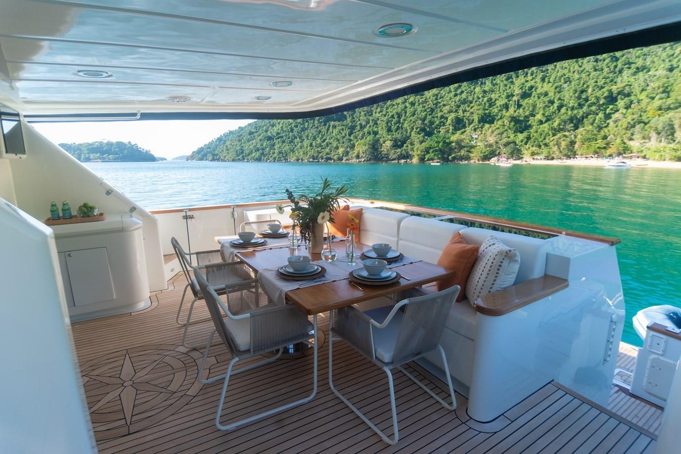 a table and chairs on a balcony aboard TATI Yacht for Sale