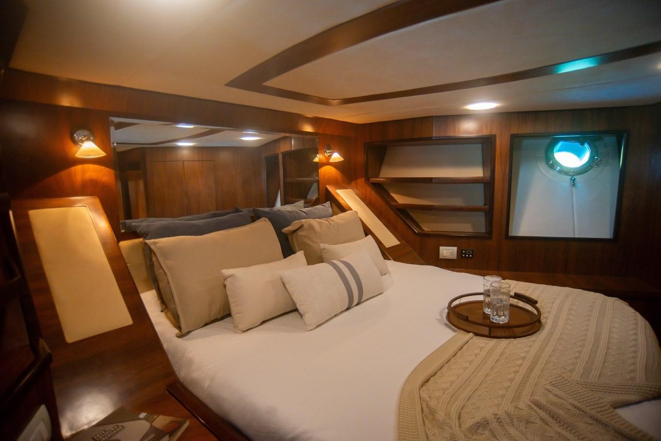 a hotel room with a bed and a table aboard TATI Yacht for Sale