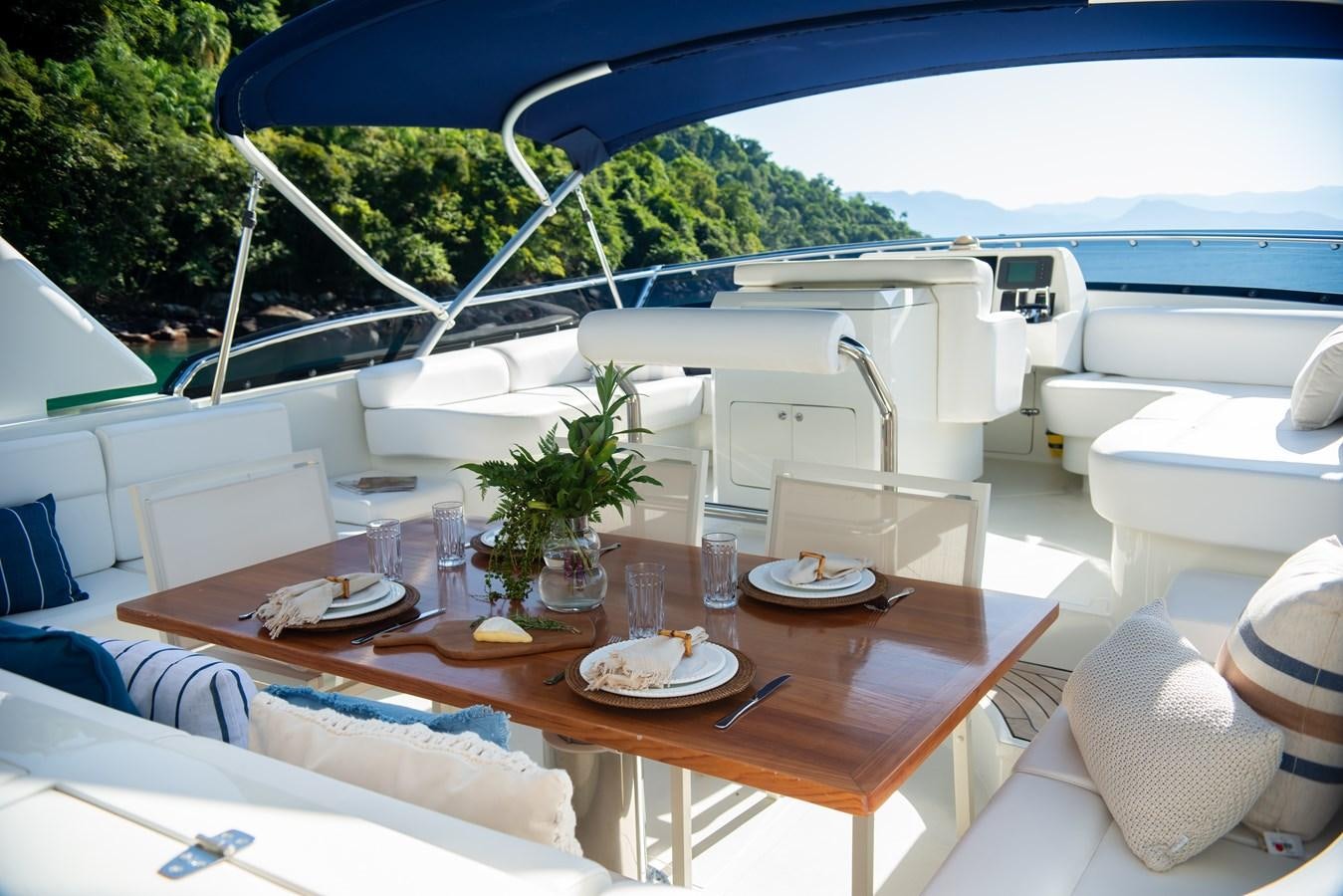 a table with plates and glasses on it aboard TATI Yacht for Sale