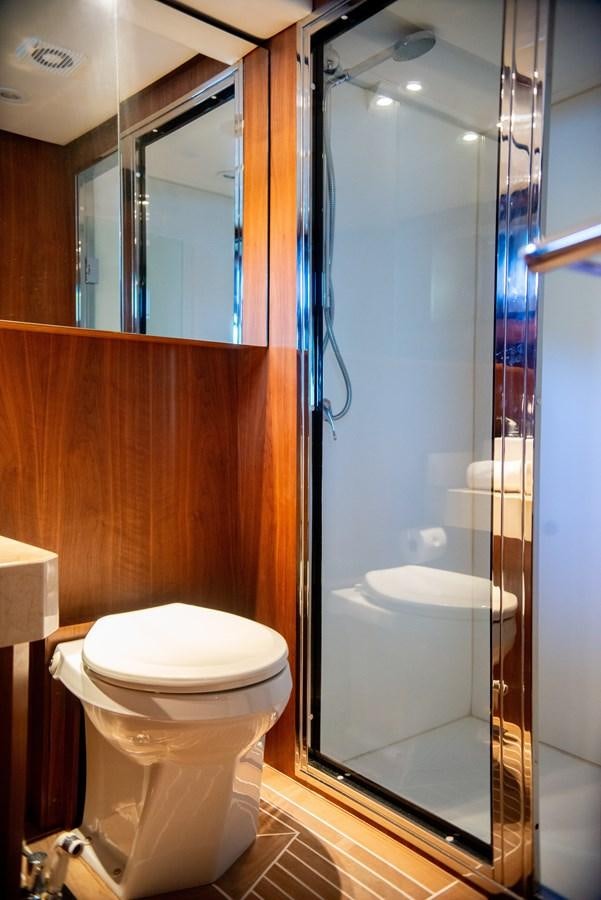 a bathroom with a glass shower aboard TATI Yacht for Sale