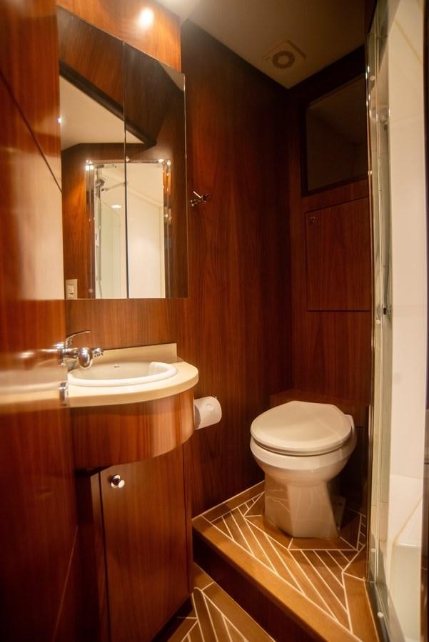 a bathroom with a toilet and a sink aboard TATI Yacht for Sale