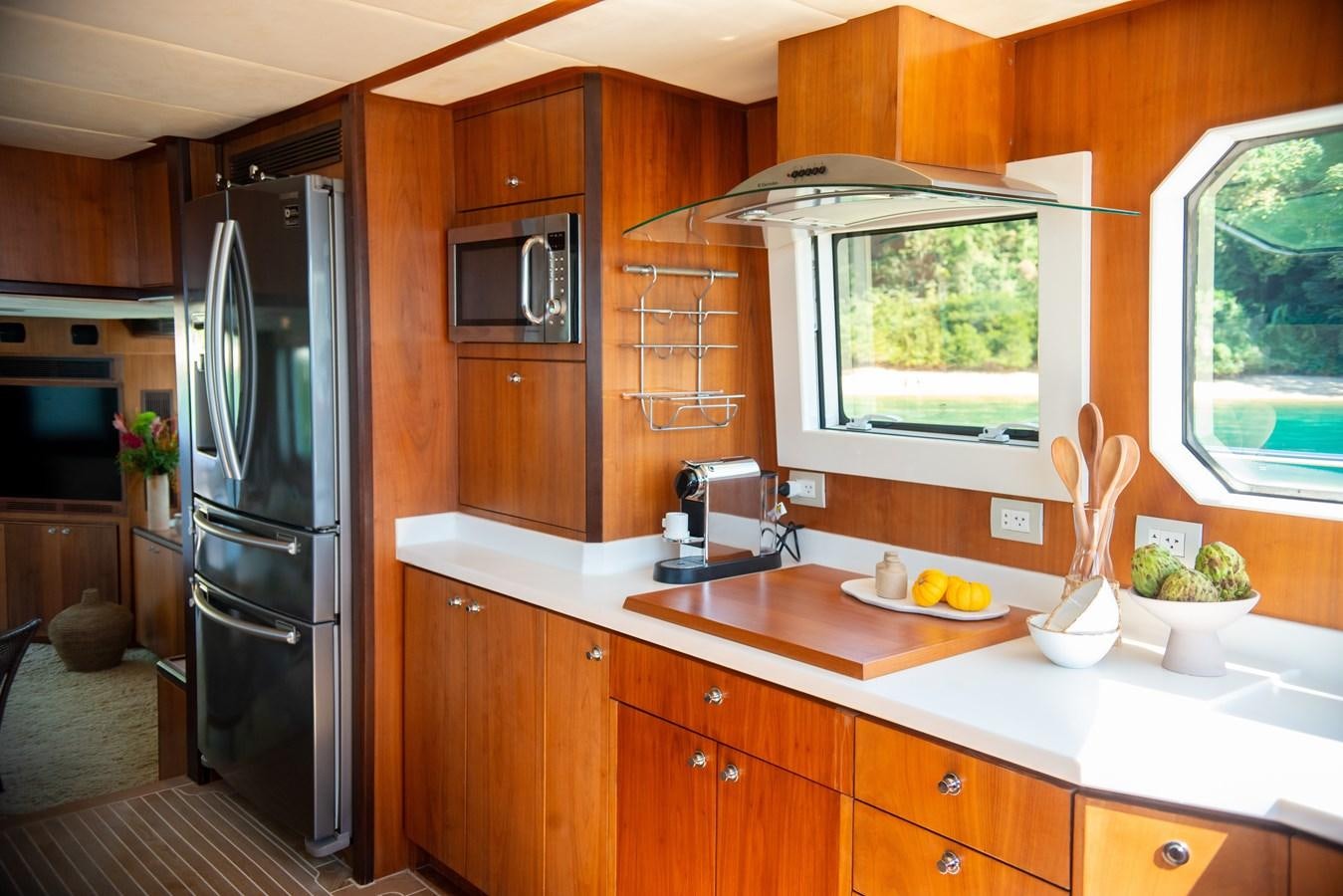 a kitchen with a refrigerator and microwave aboard TATI Yacht for Sale