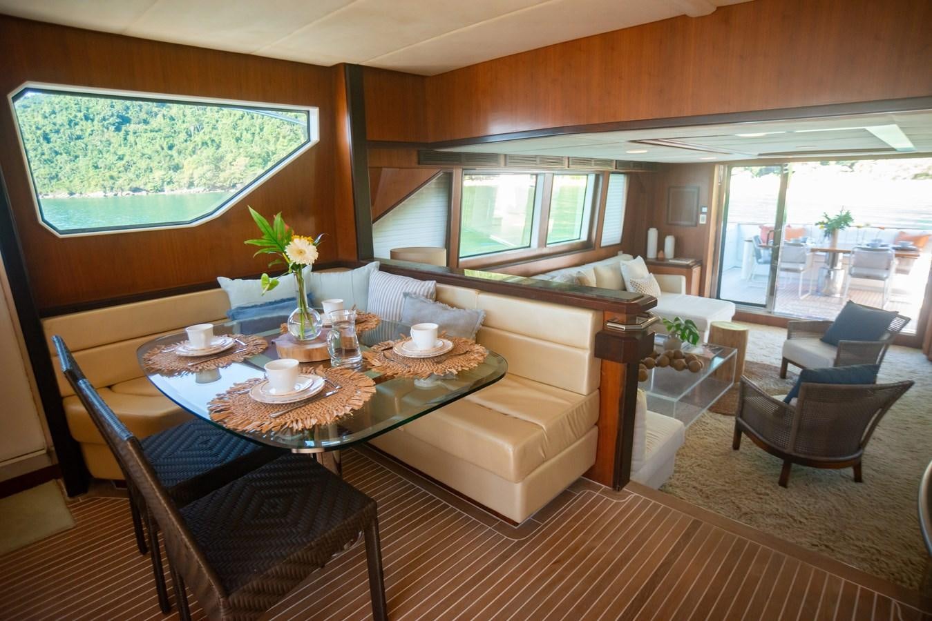a living room with a table and chairs aboard TATI Yacht for Sale