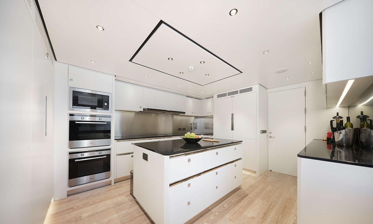 a kitchen with white cabinets aboard HEYSEA ASTERIA 139/3 Yacht for Sale