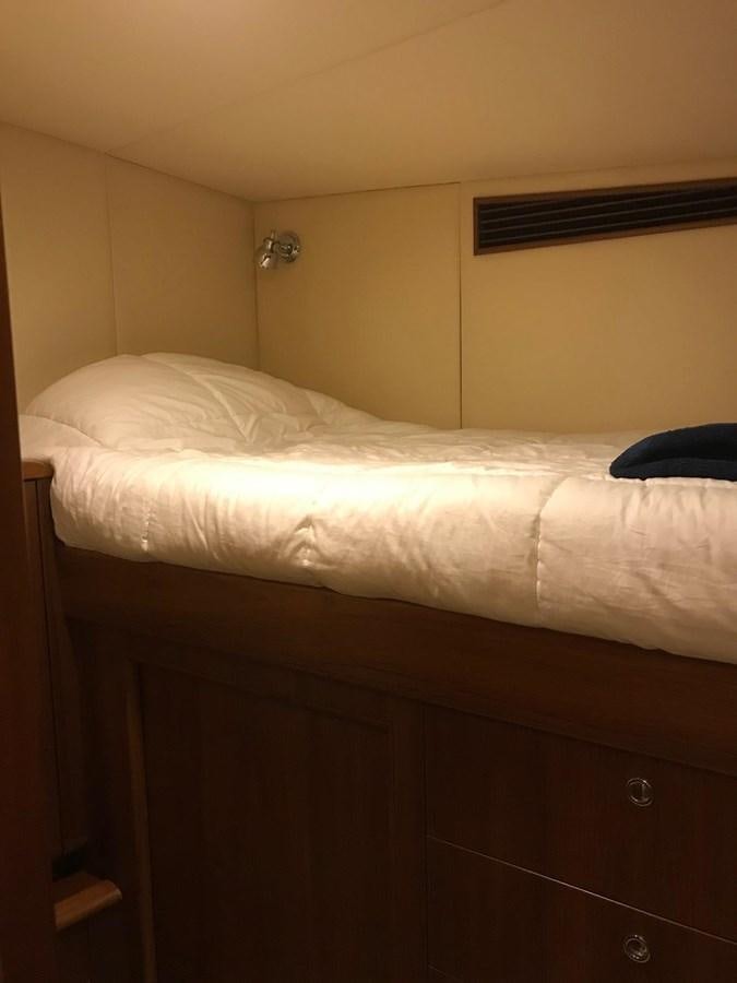 a bed with a white sheet aboard IN FLIGHT Yacht for Sale