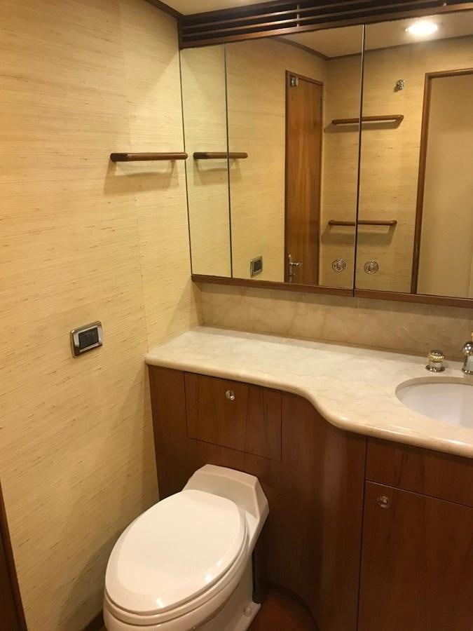 a bathroom with a toilet and a sink aboard IN FLIGHT Yacht for Sale