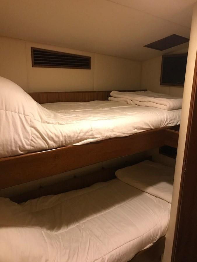 a room with a bed and a television aboard IN FLIGHT Yacht for Sale