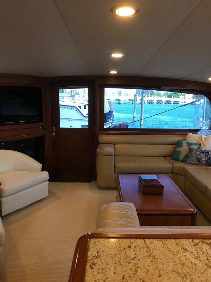 a living room with a large window aboard IN FLIGHT Yacht for Sale