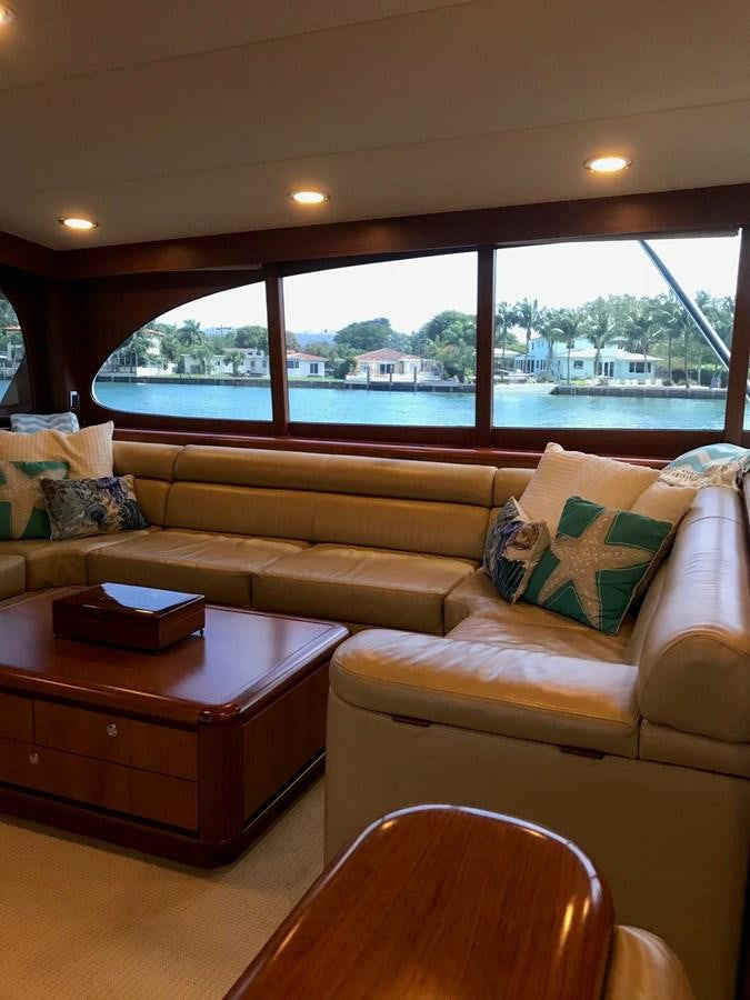 a living room with a couch and a table aboard IN FLIGHT Yacht for Sale