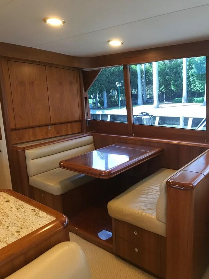 a living room with a table and couches aboard IN FLIGHT Yacht for Sale
