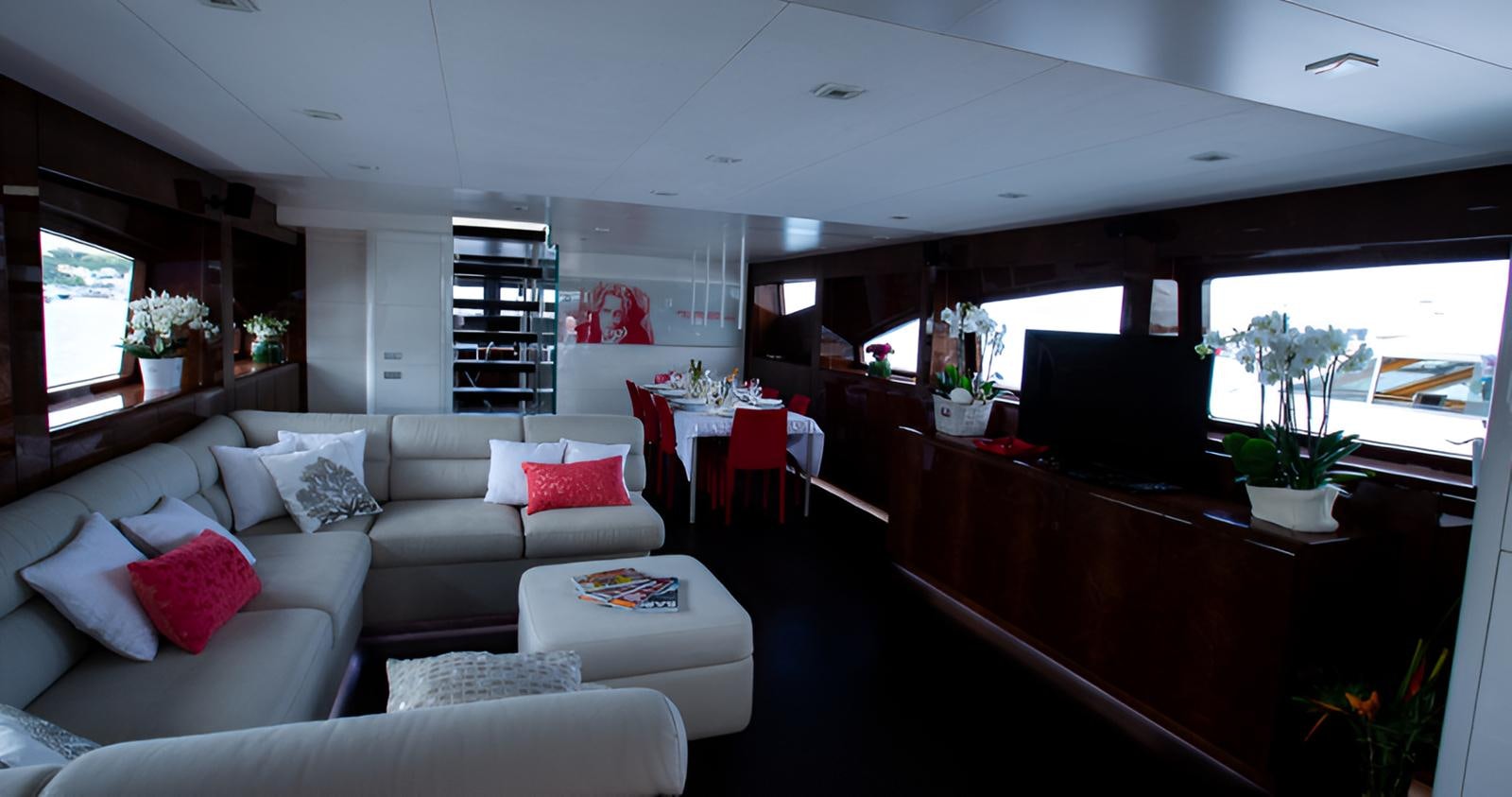 a living room with a white couch and a table aboard CAMILLA A Yacht for Sale