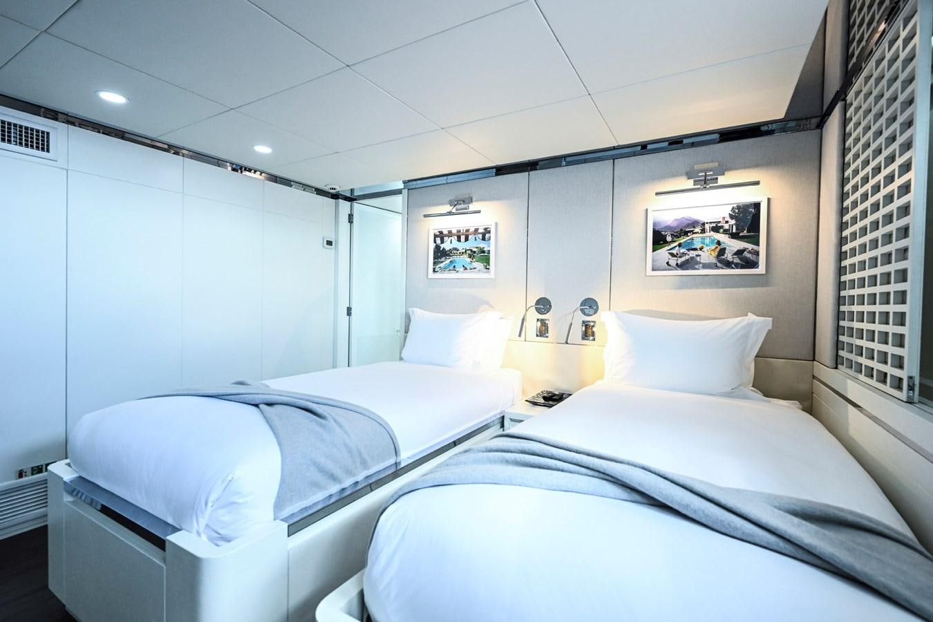 a room with white beds aboard BG CHARADE Yacht for Sale