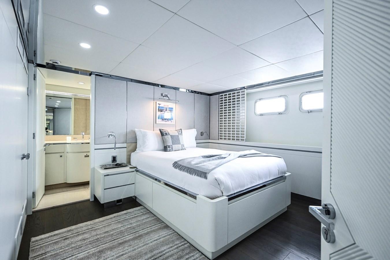 a room with a bed and a mirror aboard BG CHARADE Yacht for Sale