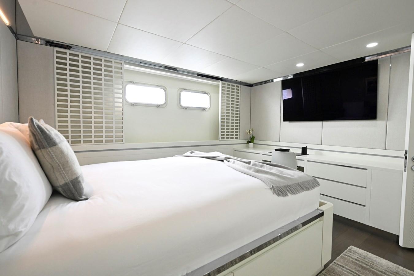 a white bedroom with a bed aboard BG CHARADE Yacht for Sale