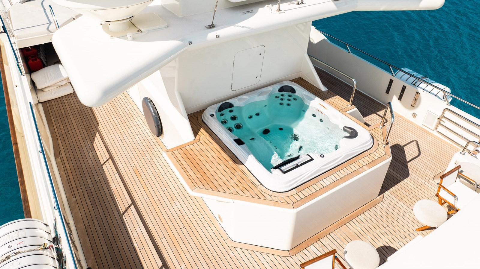 a bathtub with a sink and a bed in the background aboard BG CHARADE Yacht for Sale