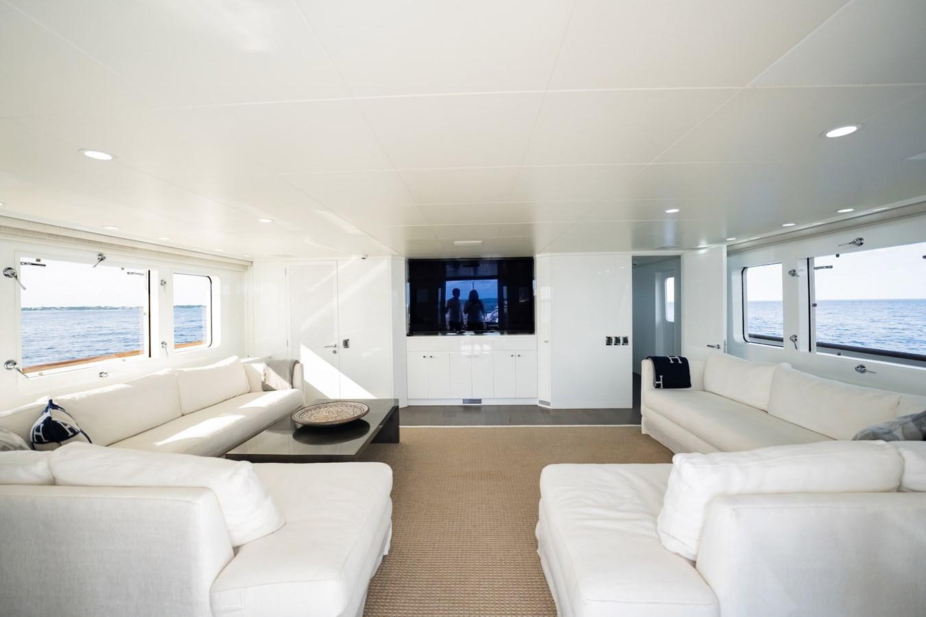 a living room with white couches aboard BG CHARADE Yacht for Sale