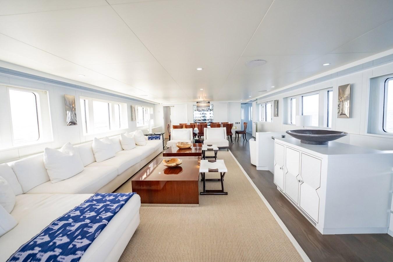 a large living room with a kitchen and dining area aboard BG CHARADE Yacht for Sale