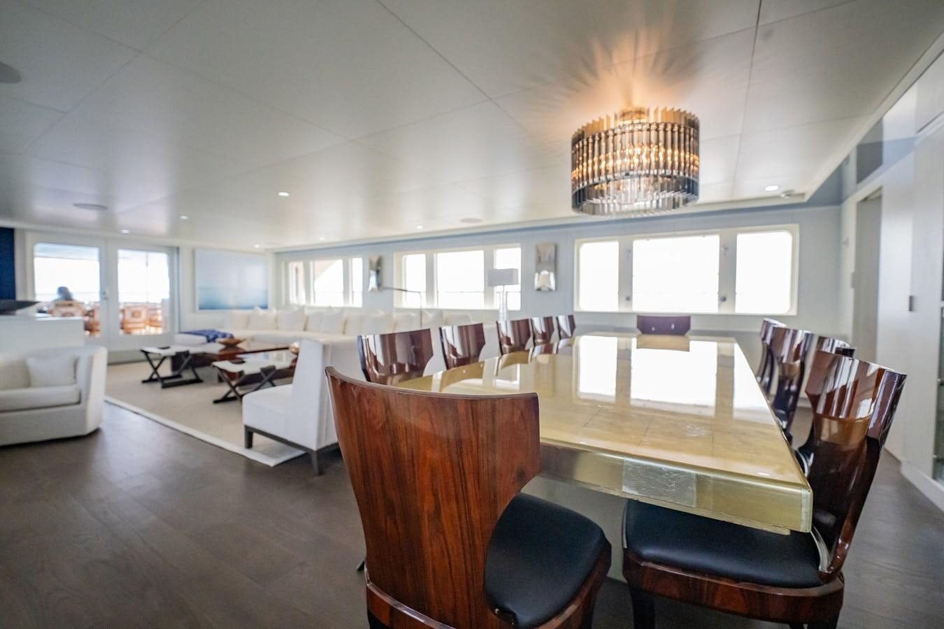 a large room with a dining table and chairs aboard BG CHARADE Yacht for Sale