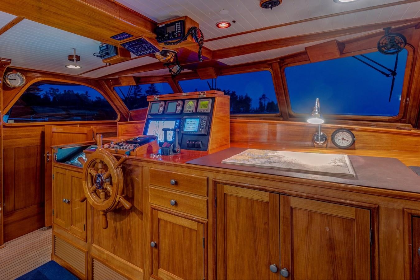 a wooden cabinet with a clock and a game console on top aboard ANNABELLE Yacht for Sale