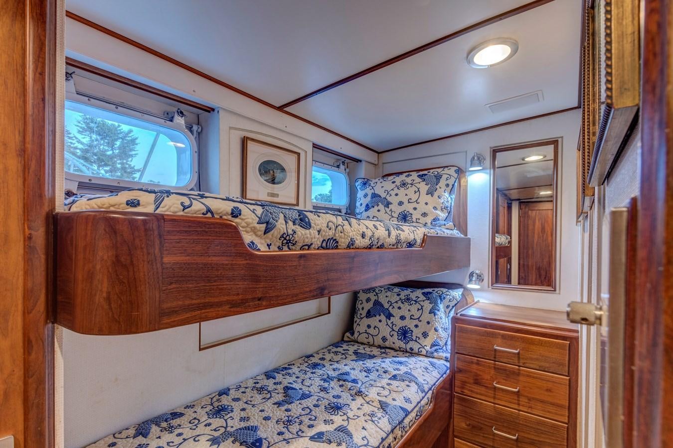 a bedroom with a bed and a dresser aboard ANNABELLE Yacht for Sale