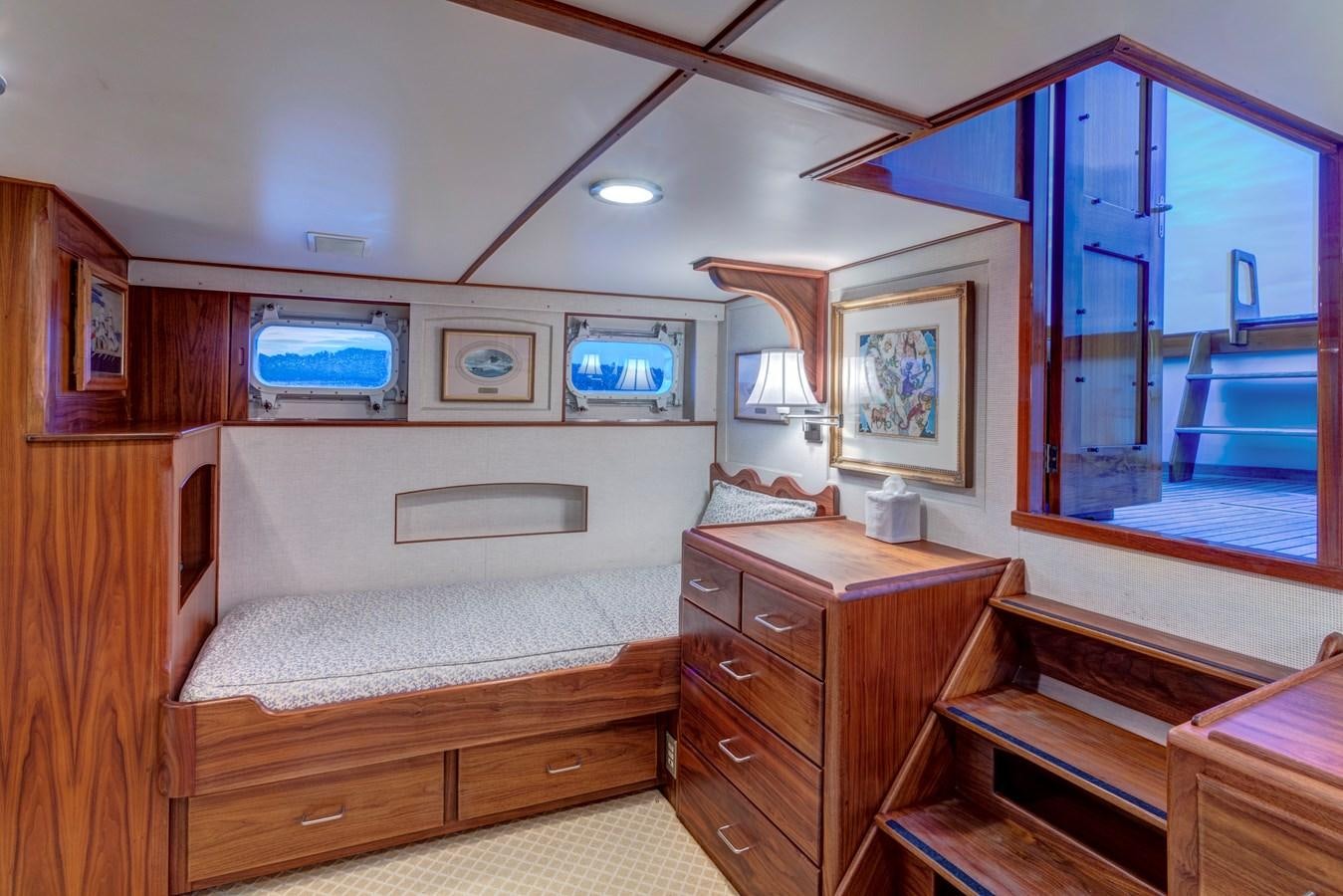 a bedroom with a bed and a tv on the wall aboard ANNABELLE Yacht for Sale