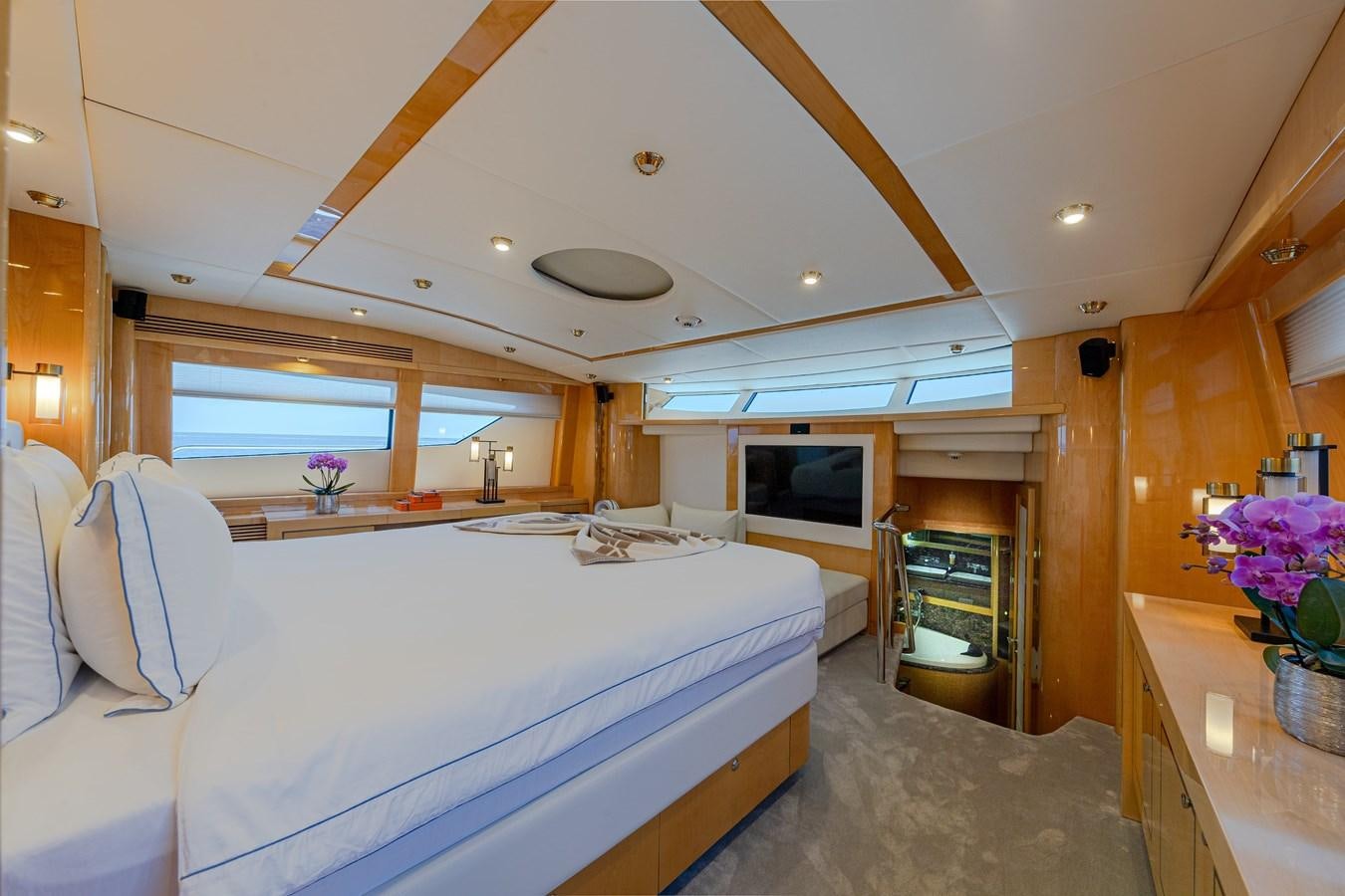 a room with a bed and a television aboard KING OF OIL Yacht for Sale