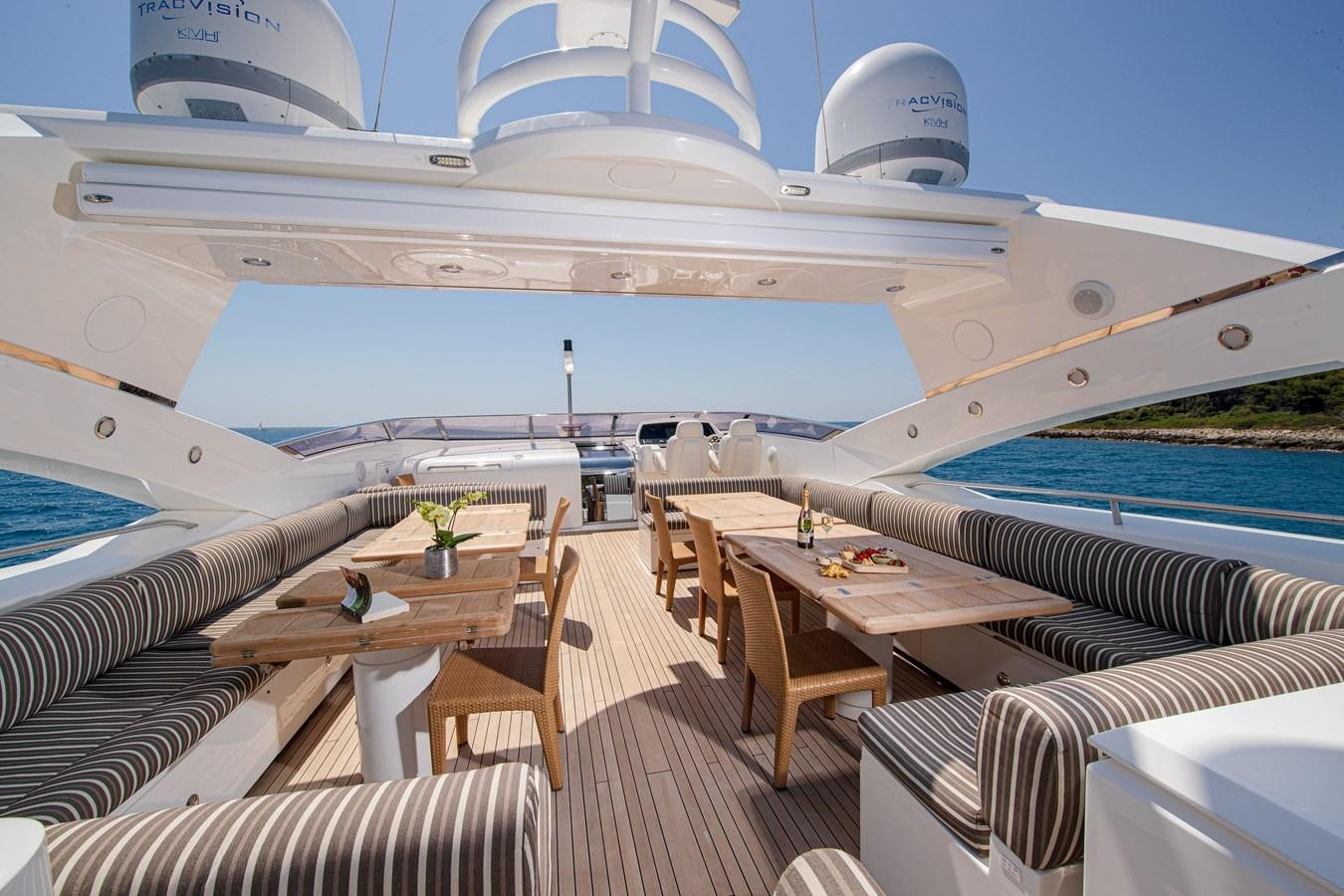 a deck with a table and chairs on it aboard KING OF OIL Yacht for Sale