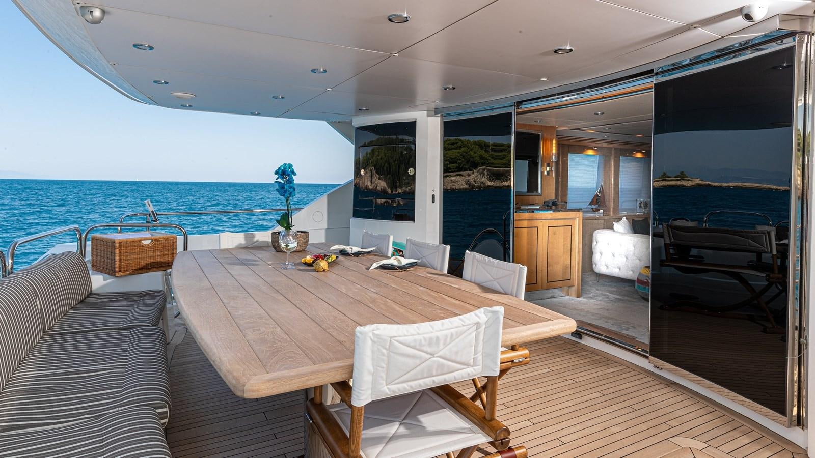 a dining table in a living room aboard KING OF OIL Yacht for Sale