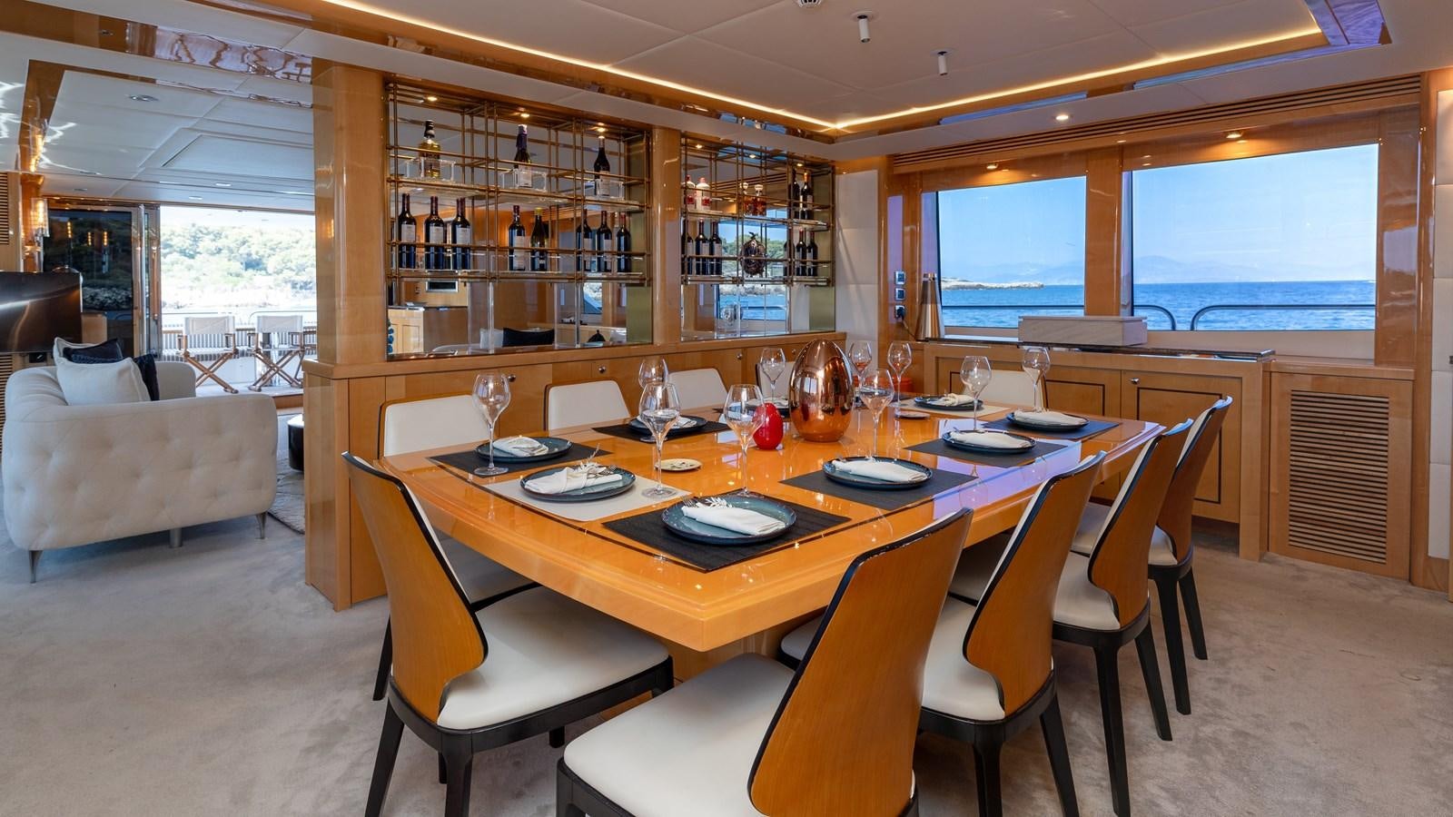 a dining room with a table set aboard KING OF OIL Yacht for Sale