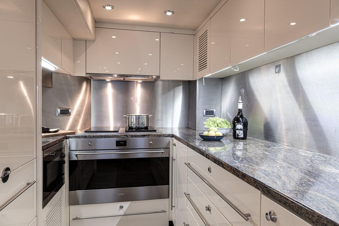 a kitchen with white cabinets aboard KING OF OIL Yacht for Sale