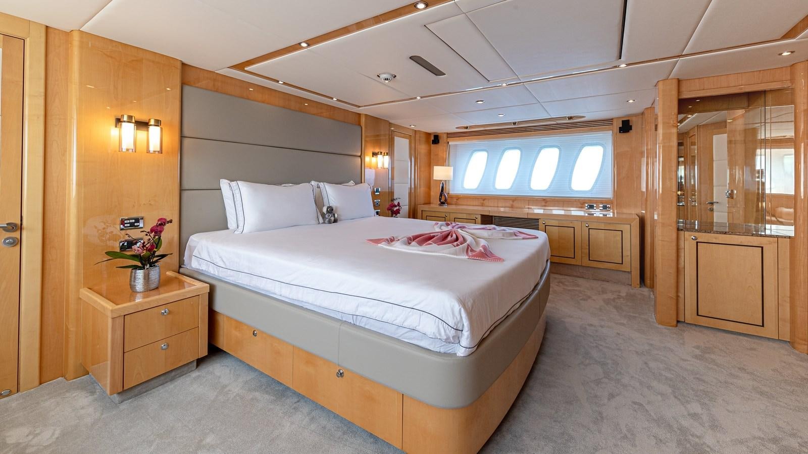 a bedroom with a bed and a closet aboard KING OF OIL Yacht for Sale