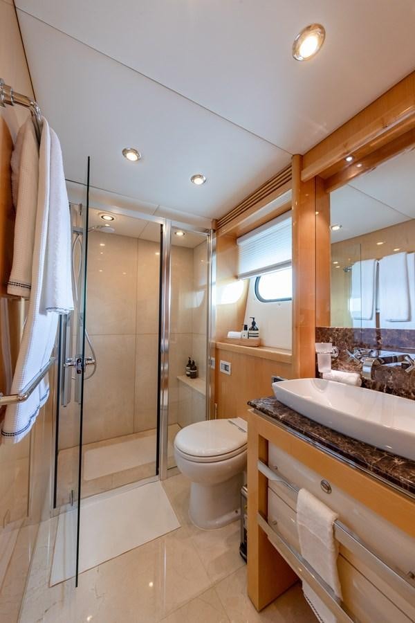 a bathroom with a glass shower aboard KING OF OIL Yacht for Sale