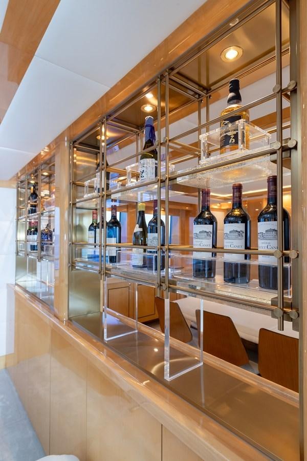 a wine rack with wine bottles aboard KING OF OIL Yacht for Sale
