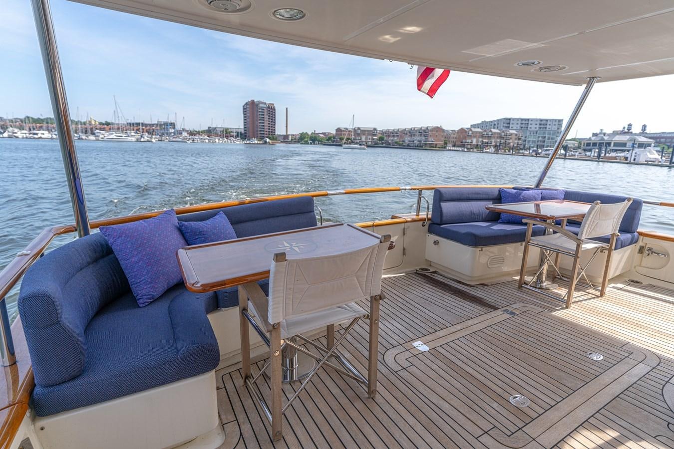 a deck with chairs and tables on it aboard UNDERDOG Yacht for Sale